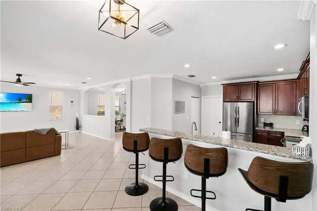 a living room with furniture and kitchen view