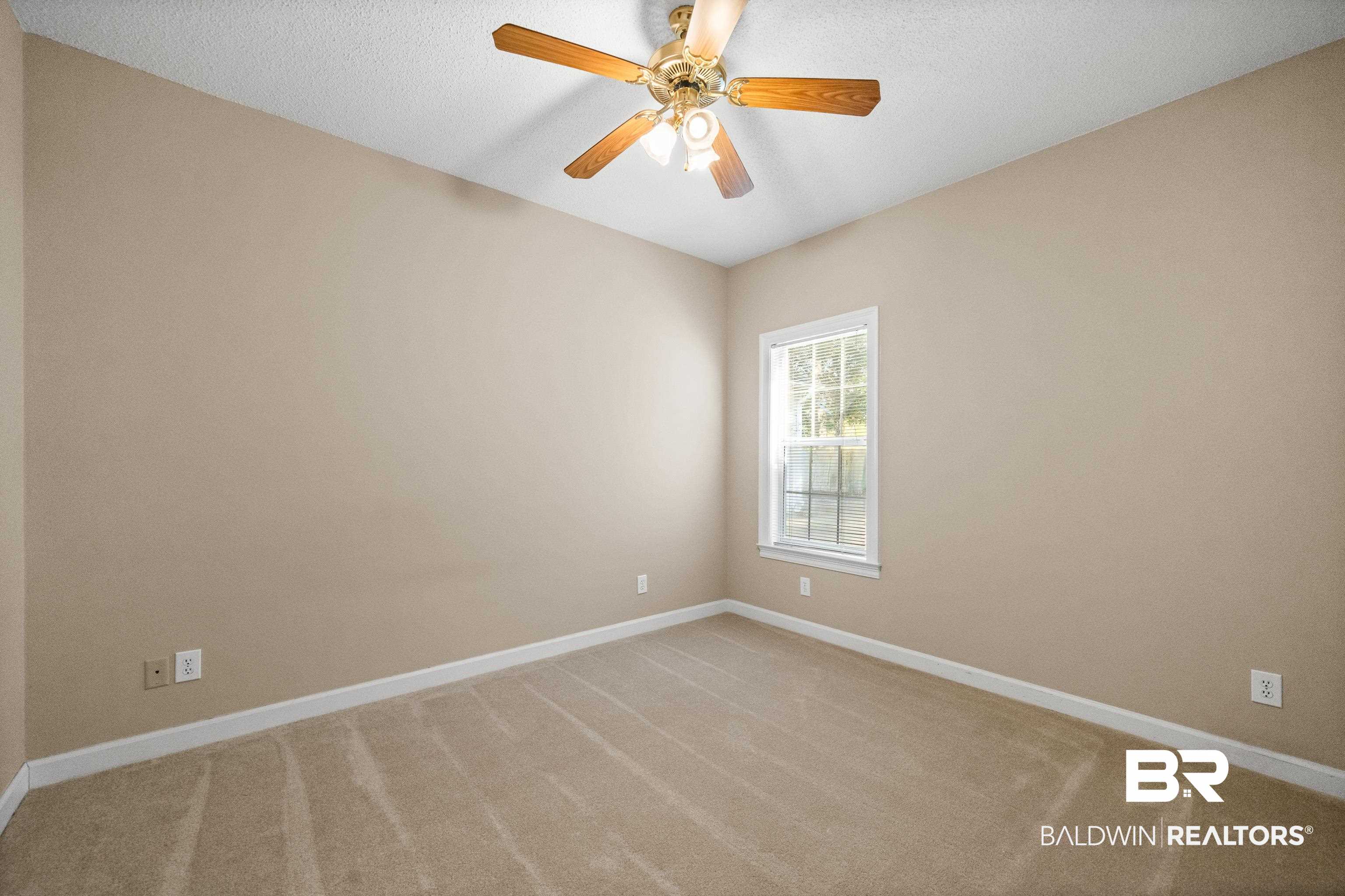 27 Cottage Drive Fairhope, AL 36532 - Photo 23 of 33 Spare room featuring light colored carpet, a ceiling fan, and a textured ceiling