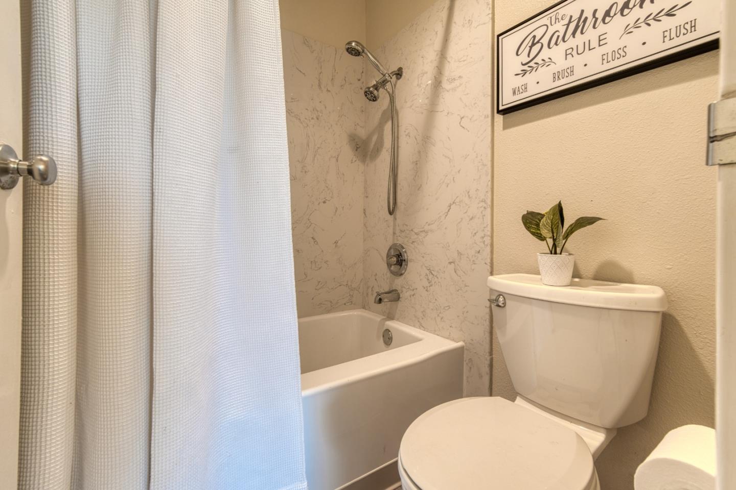 376 Imperial Way, Unit 315 Daly City, CA 94015 - Photo 13 of 29 a white toilet sitting next to a bath tub