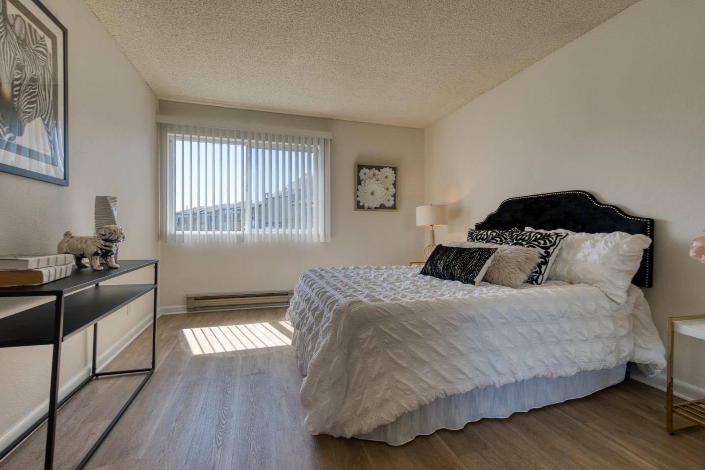 376 Imperial Way, Unit 315 Daly City, CA 94015 - Photo 15 of 29 a bedroom with a bed and wooden floor