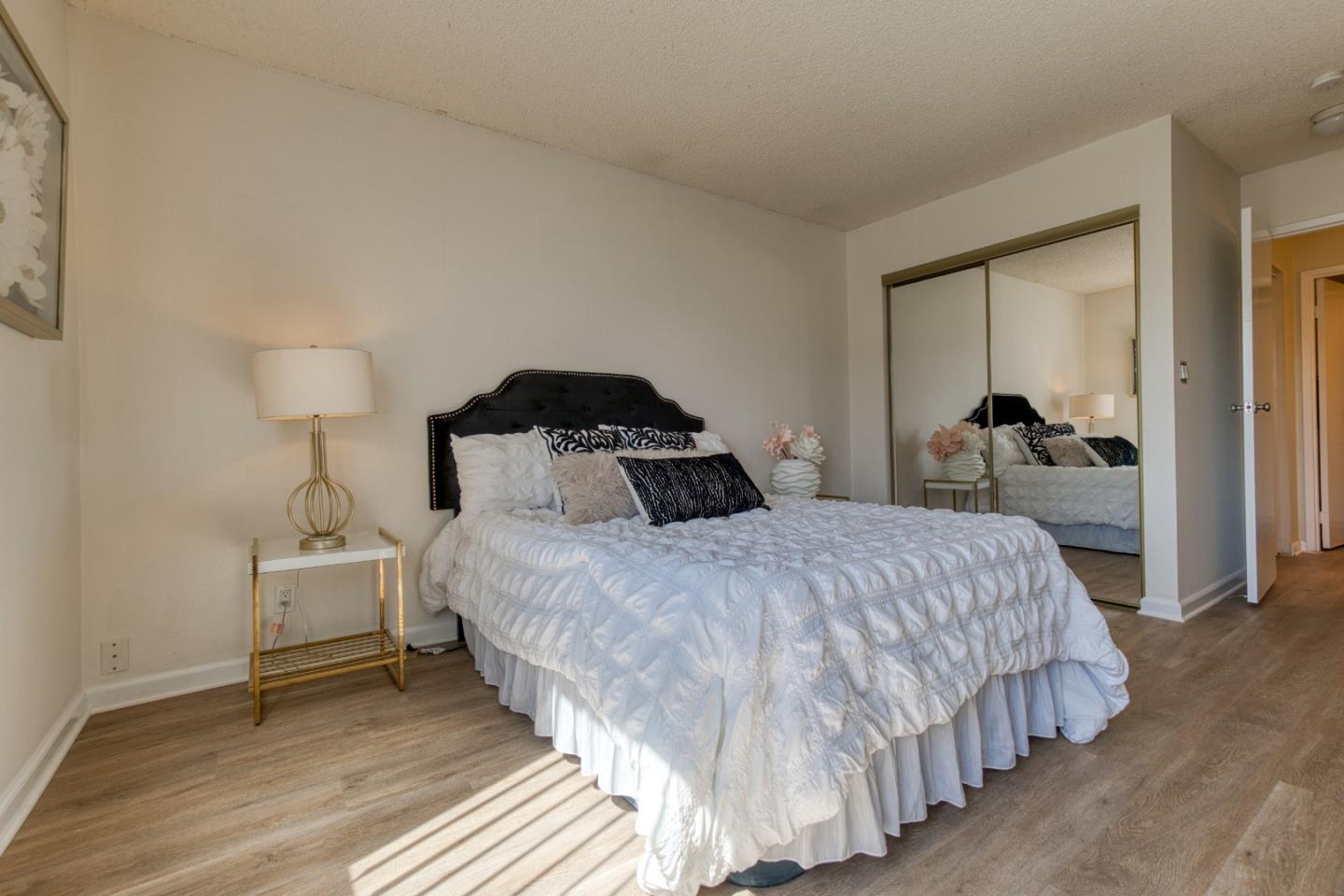 376 Imperial Way, Unit 315 Daly City, CA 94015 - Photo 17 of 29 a bedroom with a bed and wooden floor
