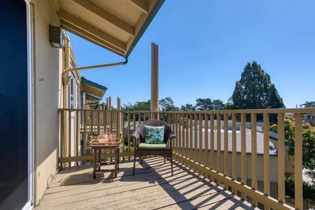 a view of balcony with wooden floor and outdoor seating