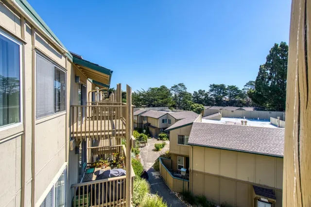 a balcony of a house with wooden floor and outdoor space
