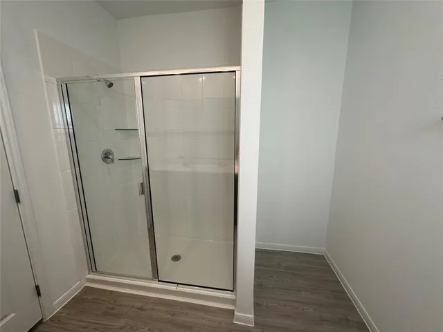 a bathroom with a glass shower door