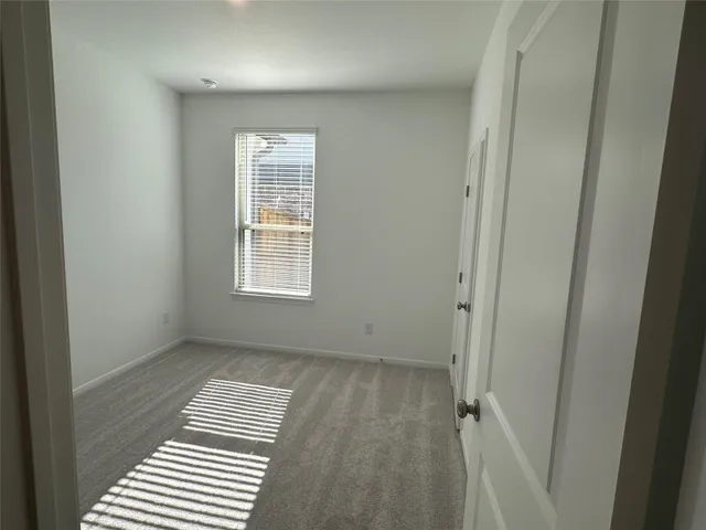 a view of a room with wooden floor and window