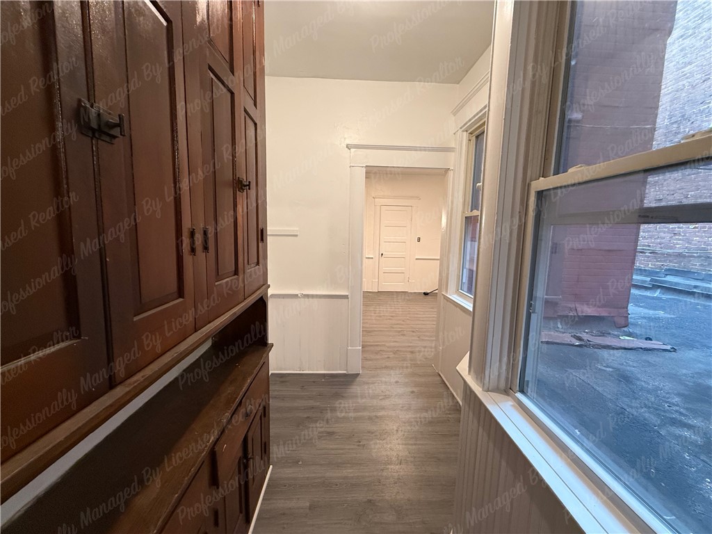 44 West High Street, Unit B Springfield, OH 45502 - Photo 21 of 31 An inviting hallway connects rooms, offering both privacy and an open feel.