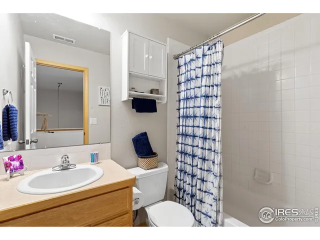 a bathroom with a sink toilet a mirror and shower