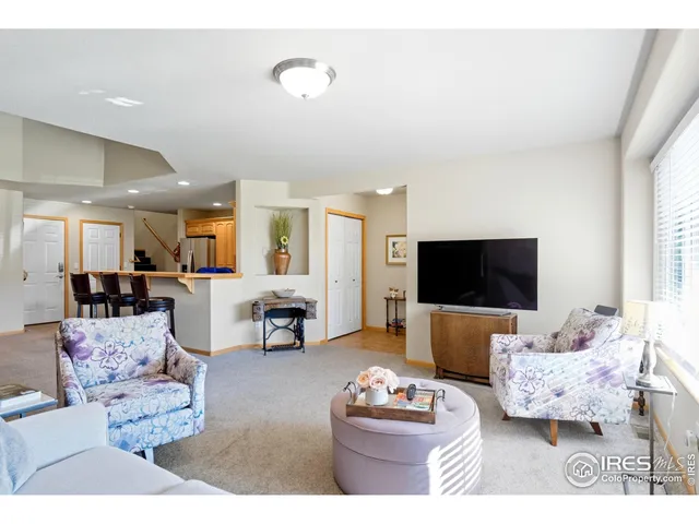 a living room with furniture a flat screen tv and a couch