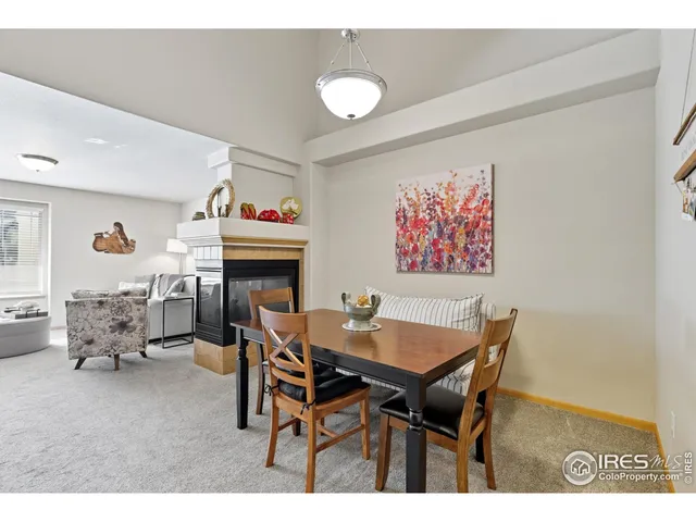 a dining room with furniture and a chandelier