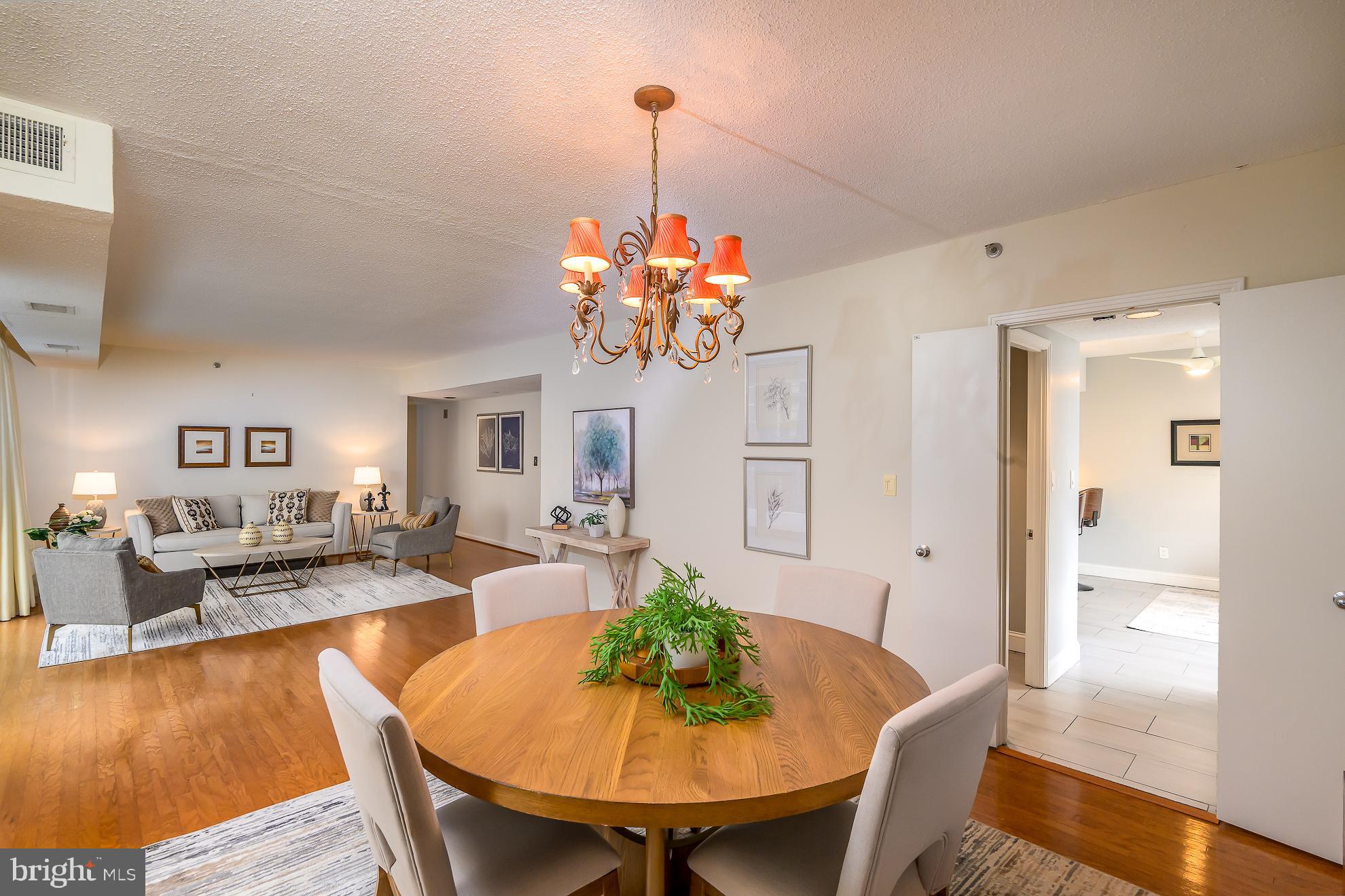 1016 South Wayne Street, Unit 604 Arlington, VA 22204 - Photo 11 of 42 a view of a dining room with furniture window and wooden floor