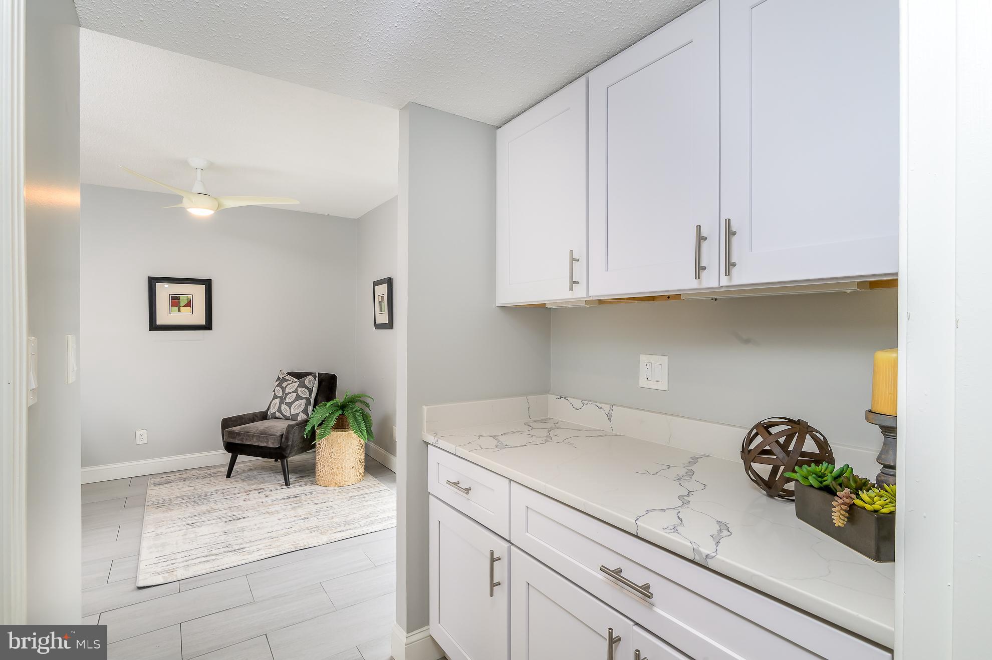 1016 South Wayne Street, Unit 604 Arlington, VA 22204 - Photo 12 of 42 a sink with cabinets and wooden floor