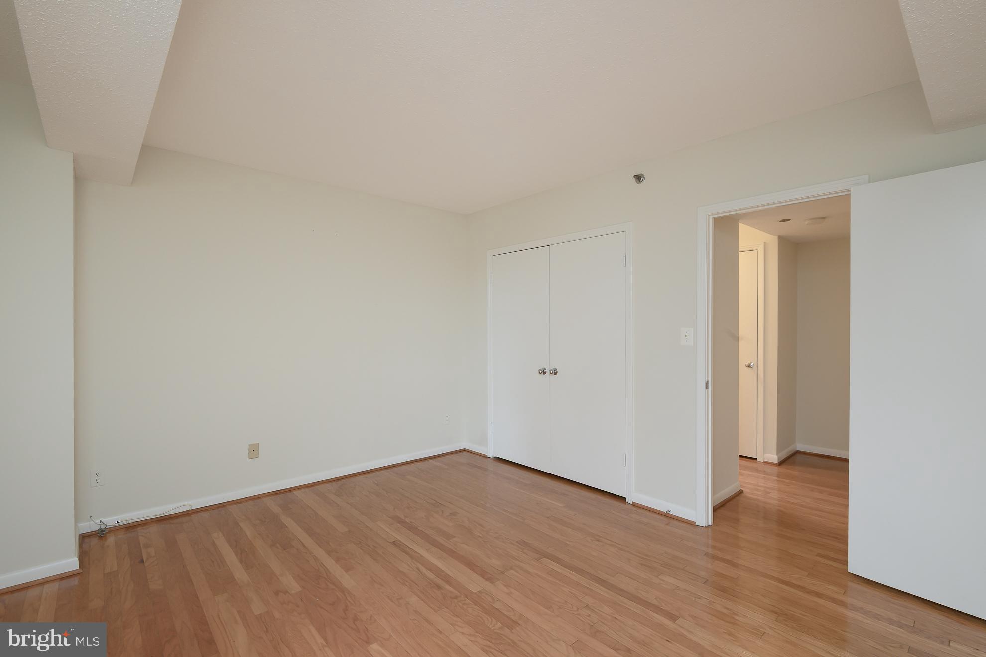 1016 South Wayne Street, Unit 604 Arlington, VA 22204 - Photo 23 of 42 a view of an empty room with wooden floor