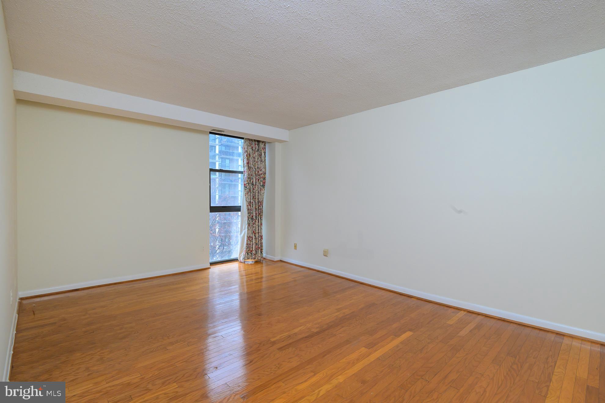 1016 South Wayne Street, Unit 604 Arlington, VA 22204 - Photo 30 of 42 a view of an empty room with wooden floor and a window