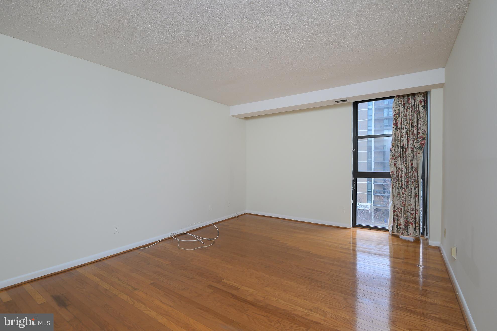1016 South Wayne Street, Unit 604 Arlington, VA 22204 - Photo 31 of 42 wooden floor in an empty room