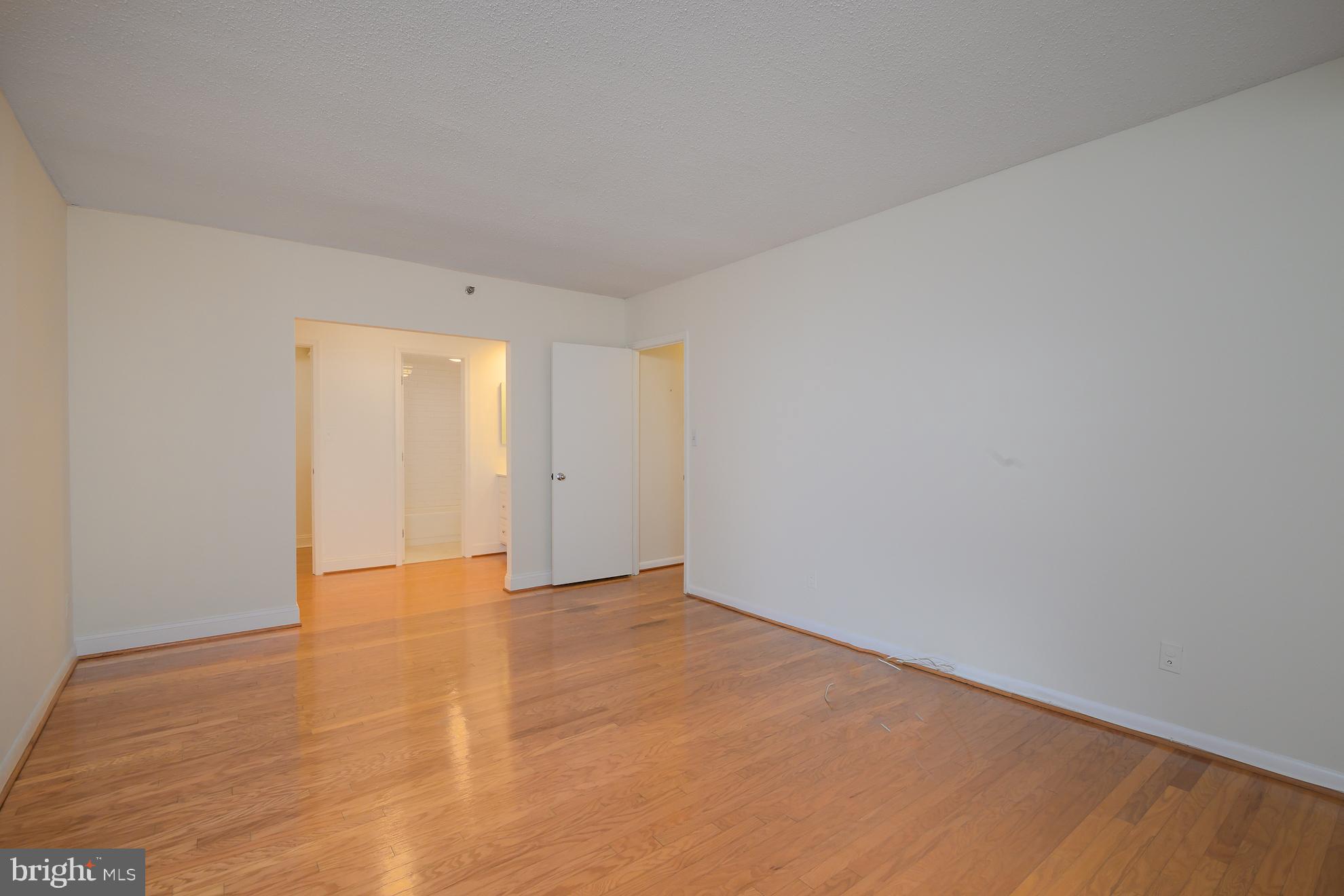 1016 South Wayne Street, Unit 604 Arlington, VA 22204 - Photo 32 of 42 a view of an empty room and wooden floor