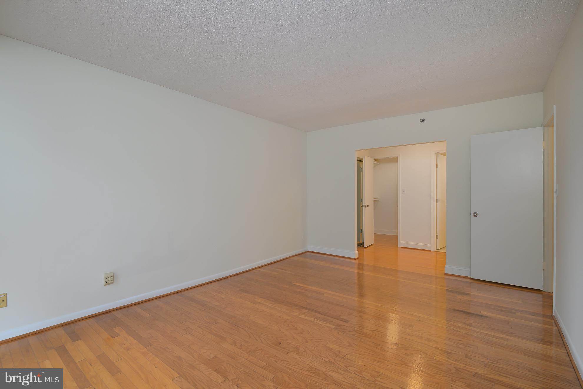 1016 South Wayne Street, Unit 604 Arlington, VA 22204 - Photo 33 of 42 a view of an empty room and wooden floor