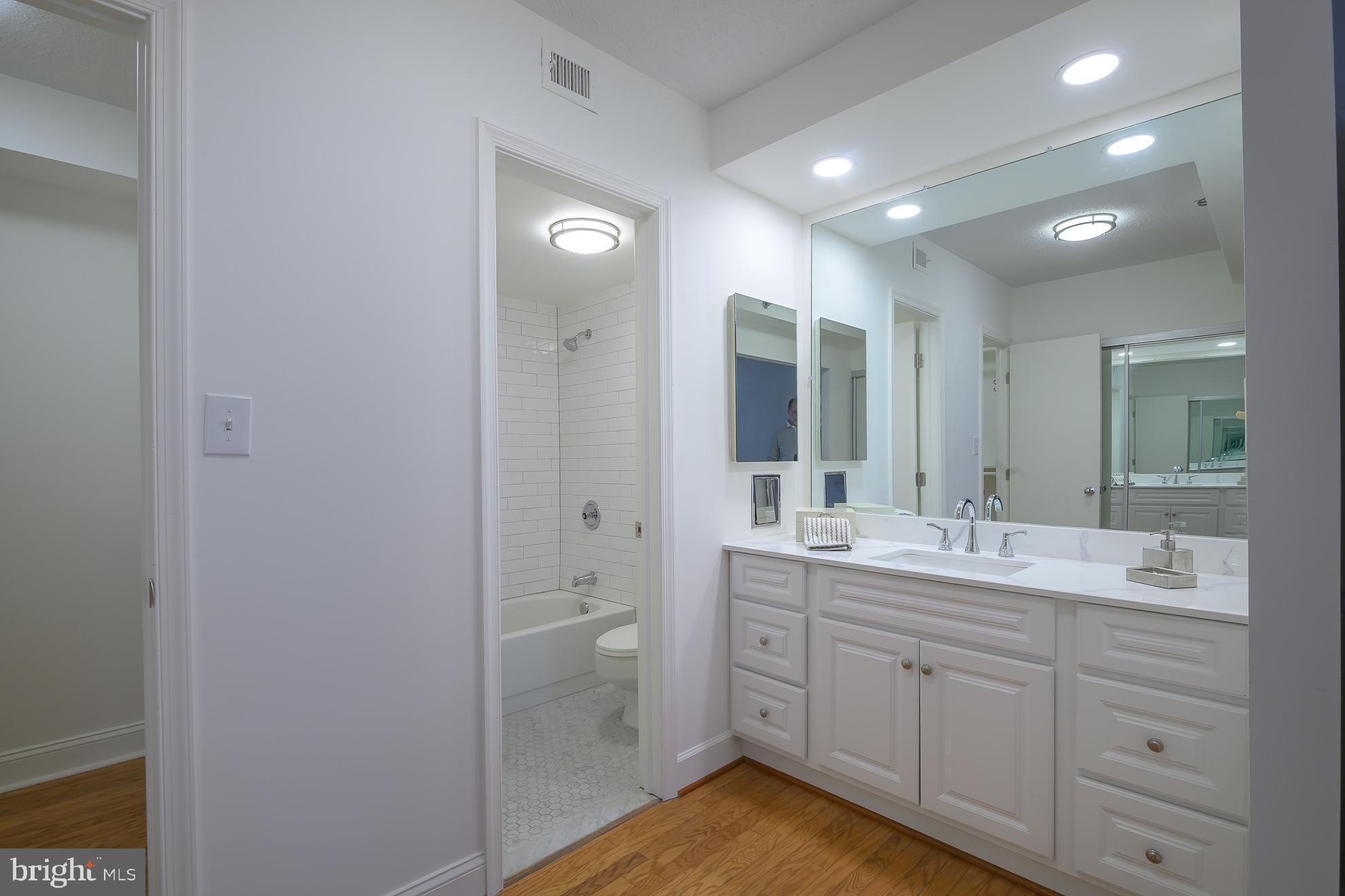 1016 South Wayne Street, Unit 604 Arlington, VA 22204 - Photo 35 of 42 a spacious bathroom with a double vanity sink a mirror and a shower