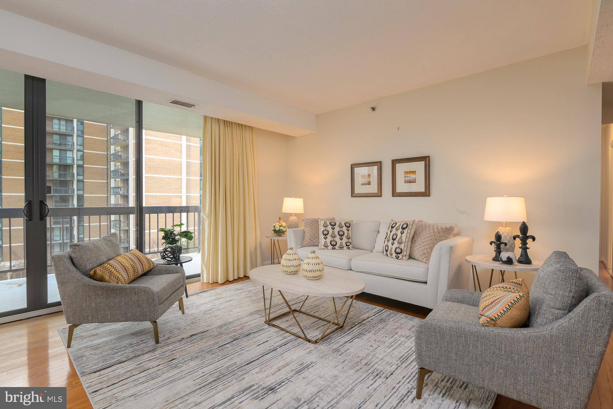 1016 South Wayne Street, Unit 604 Arlington, VA 22204 - Photo 4 of 42 a living room with furniture and a large window