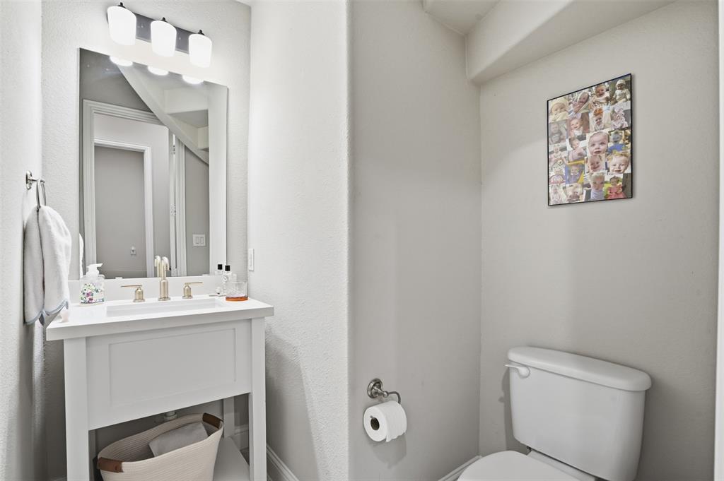 9435 Rockmount Drive Dallas, TX 75243 - Photo 24 of 32 a bathroom with a toilet sink and mirror