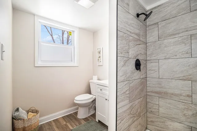 a bathroom with a toilet and a shower