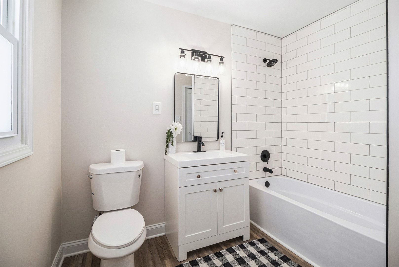 18947 Ridgewood Avenue Lansing, IL 60438 - Photo 16 of 21 a bathroom with a toilet a sink a mirror a bathtub and vanity