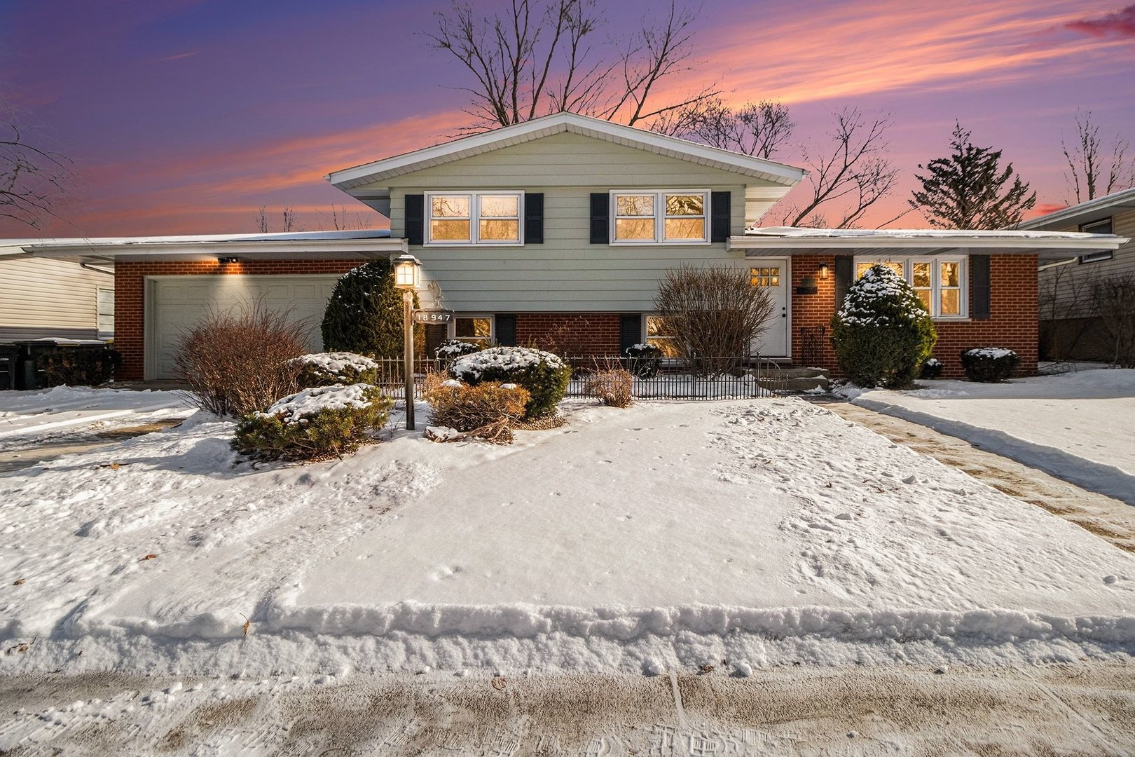 18947 Ridgewood Avenue Lansing, IL 60438 - Photo 2 of 21 a front view of a house with patio