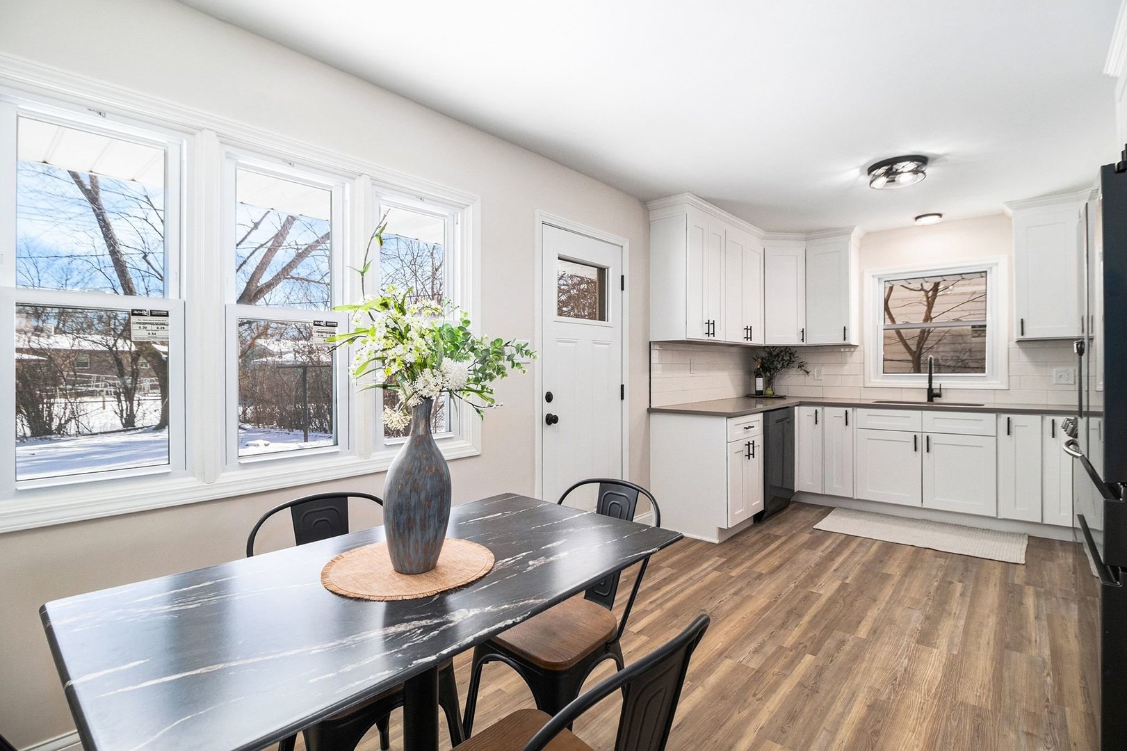 18947 Ridgewood Avenue Lansing, IL 60438 - Photo 6 of 21 a kitchen with stainless steel appliances granite countertop a dining table chairs a granite counter tops and a window