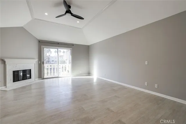 a view of an empty room with a fireplace and a window