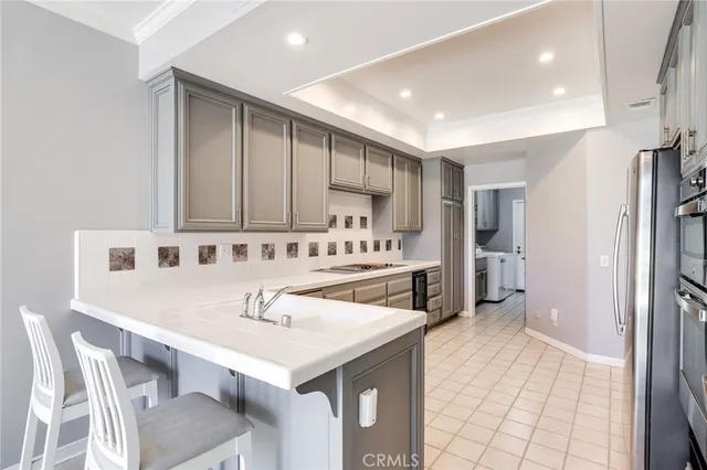 a kitchen with a sink cabinets and refrigerator