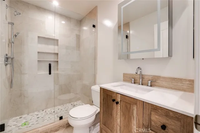 a bathroom with a sink toilet and shower