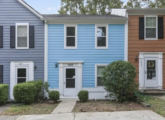 a view of a brick house many windows