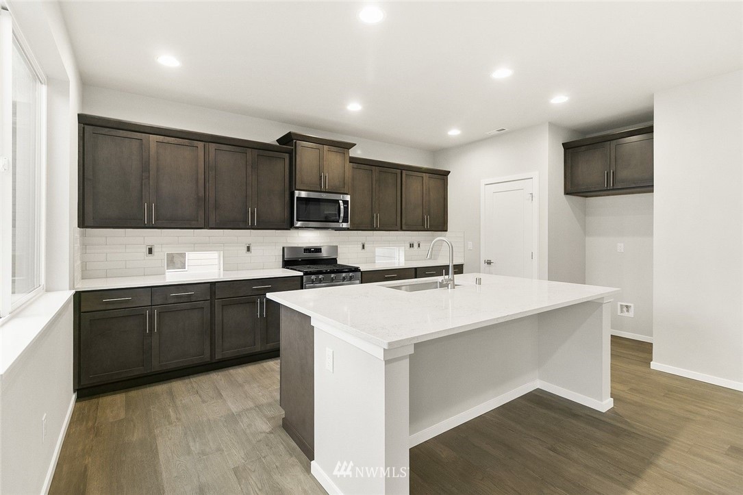 26832 102nd Place Southeast Kent, WA 98030 - Photo 11 of 31 a kitchen with kitchen island a sink stainless steel appliances and cabinets