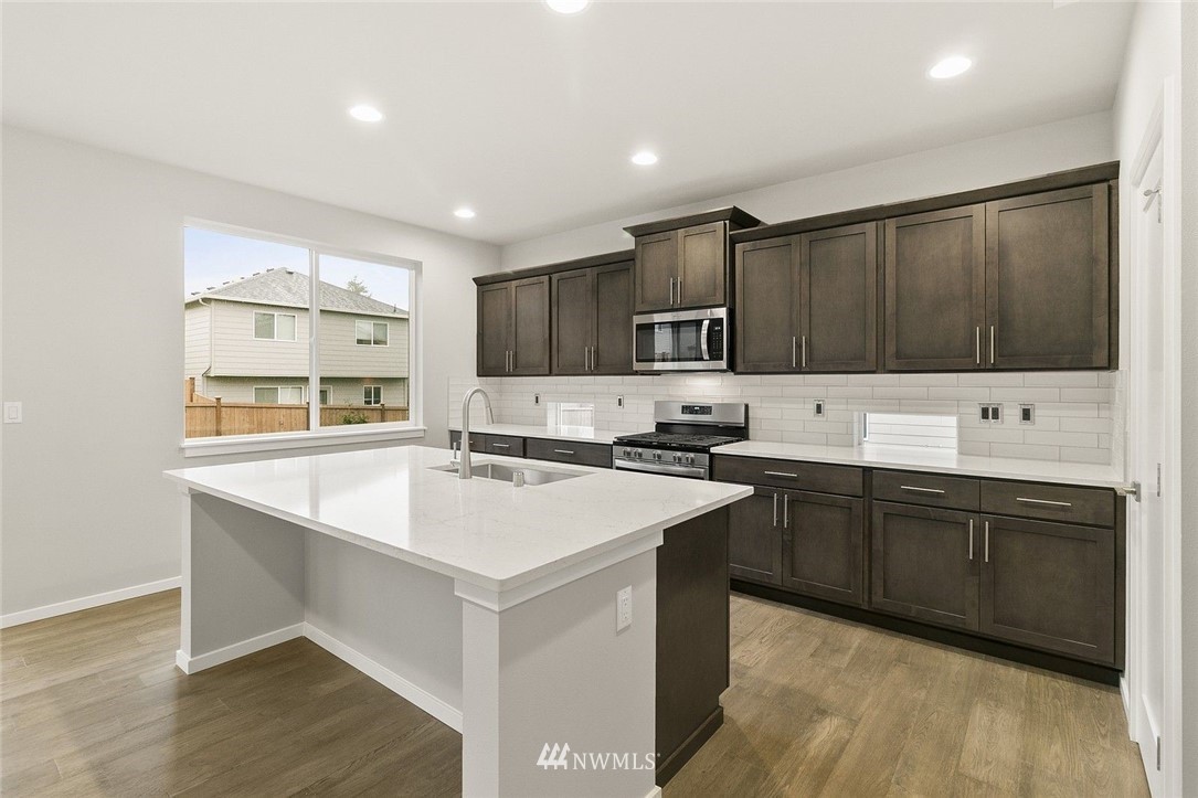 26832 102nd Place Southeast Kent, WA 98030 - Photo 12 of 31 a kitchen with kitchen island a sink appliances and cabinets