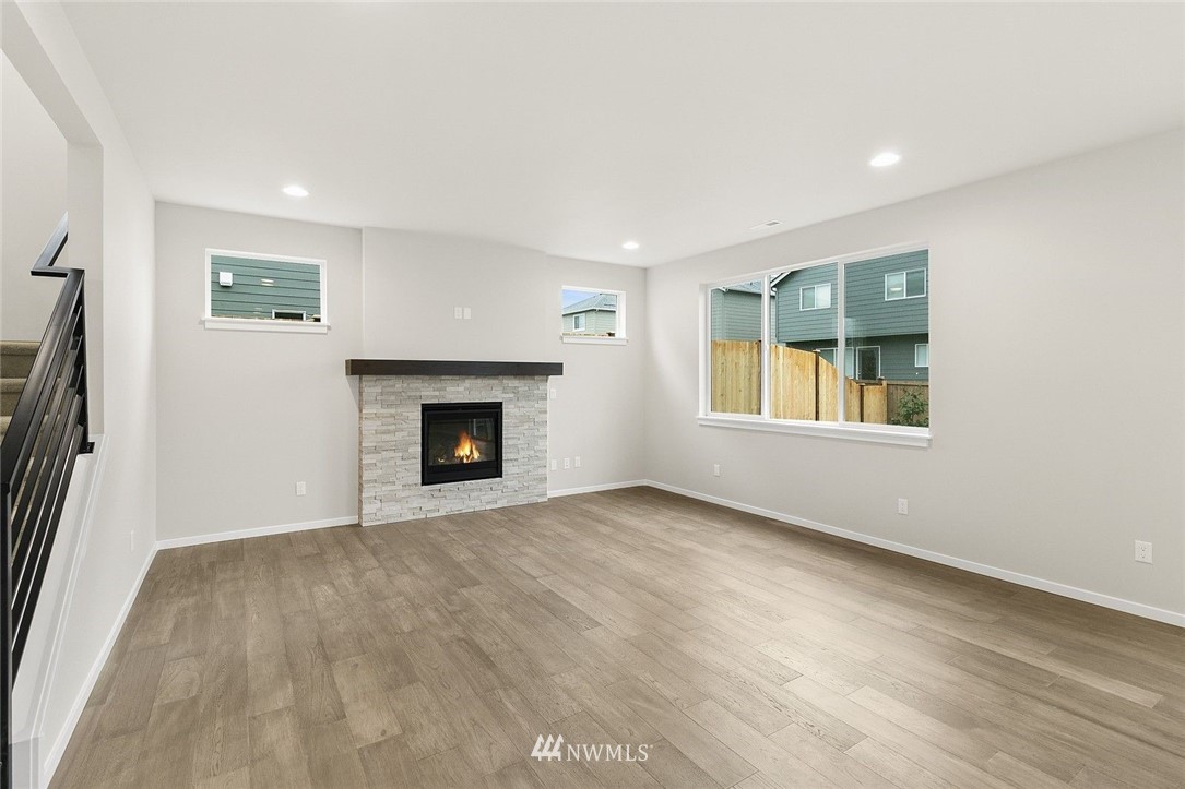 26832 102nd Place Southeast Kent, WA 98030 - Photo 5 of 31 a view of an empty room with a fireplace and a window