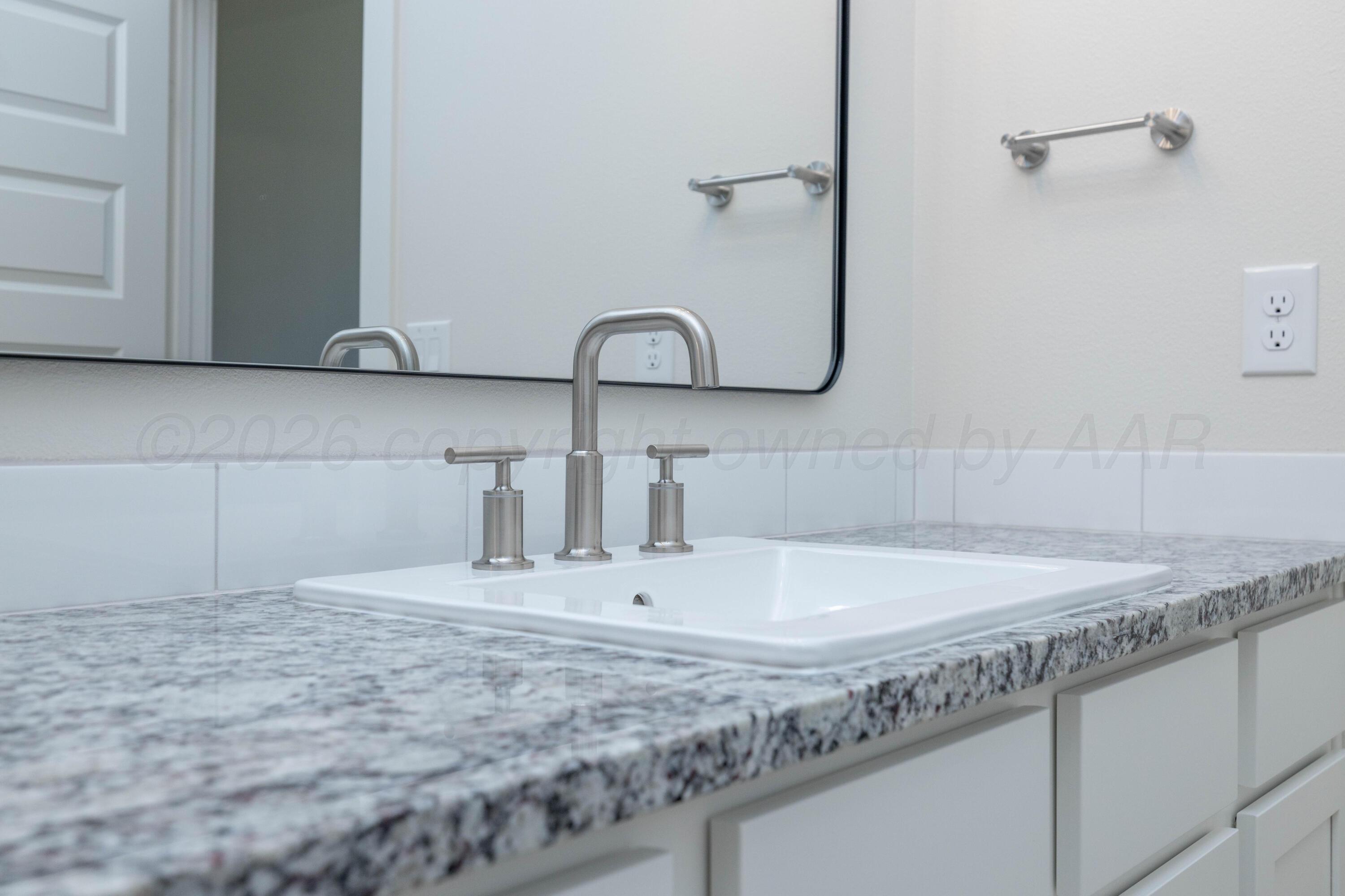 3006 Frontier Lane Amarillo, TX 79124 - Photo 11 of 16 a bathroom with a sink and a mirror
