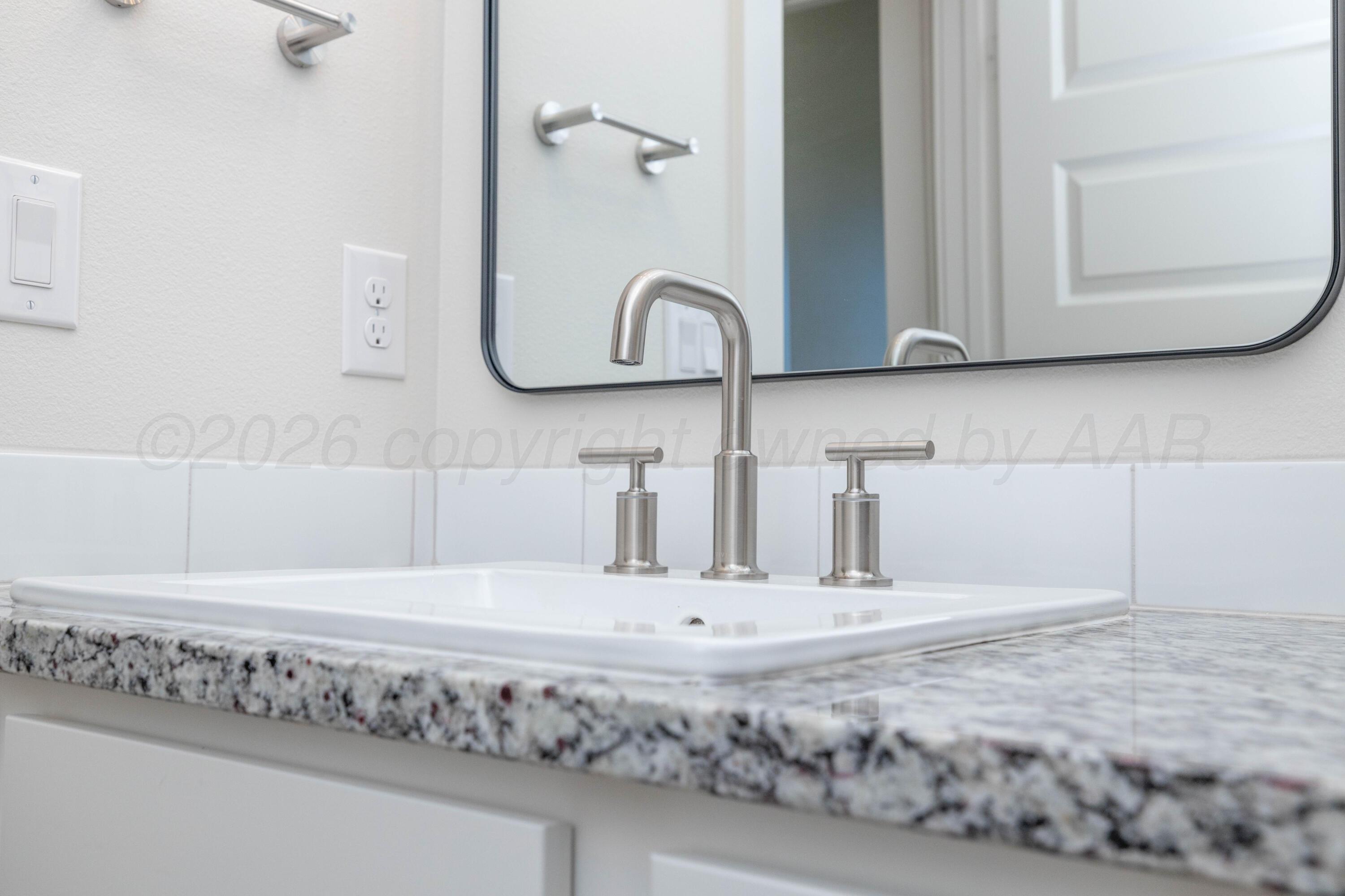 3006 Frontier Lane Amarillo, TX 79124 - Photo 15 of 16 a bathroom with a sink and a mirror
