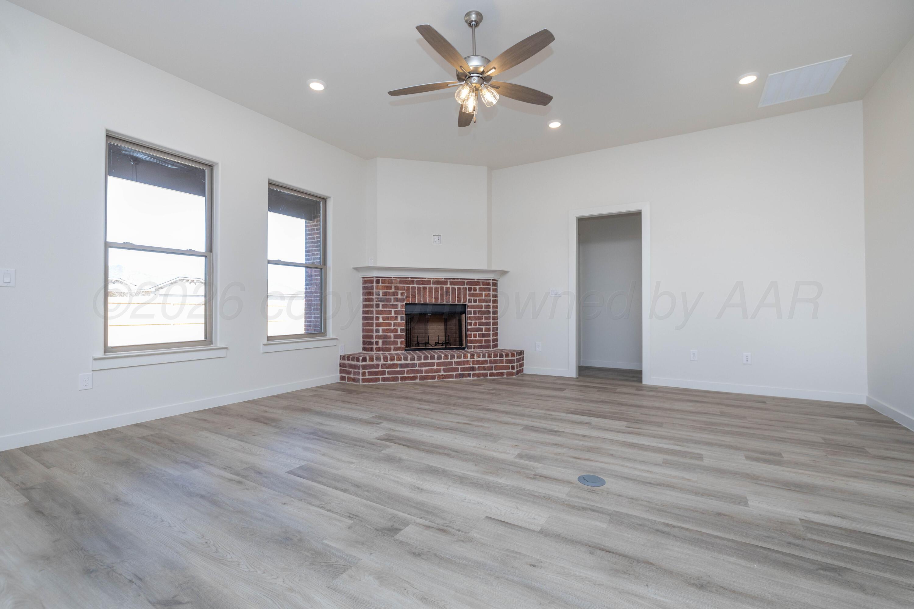 3006 Frontier Lane Amarillo, TX 79124 - Photo 4 of 16 an empty room with windows and a fireplace