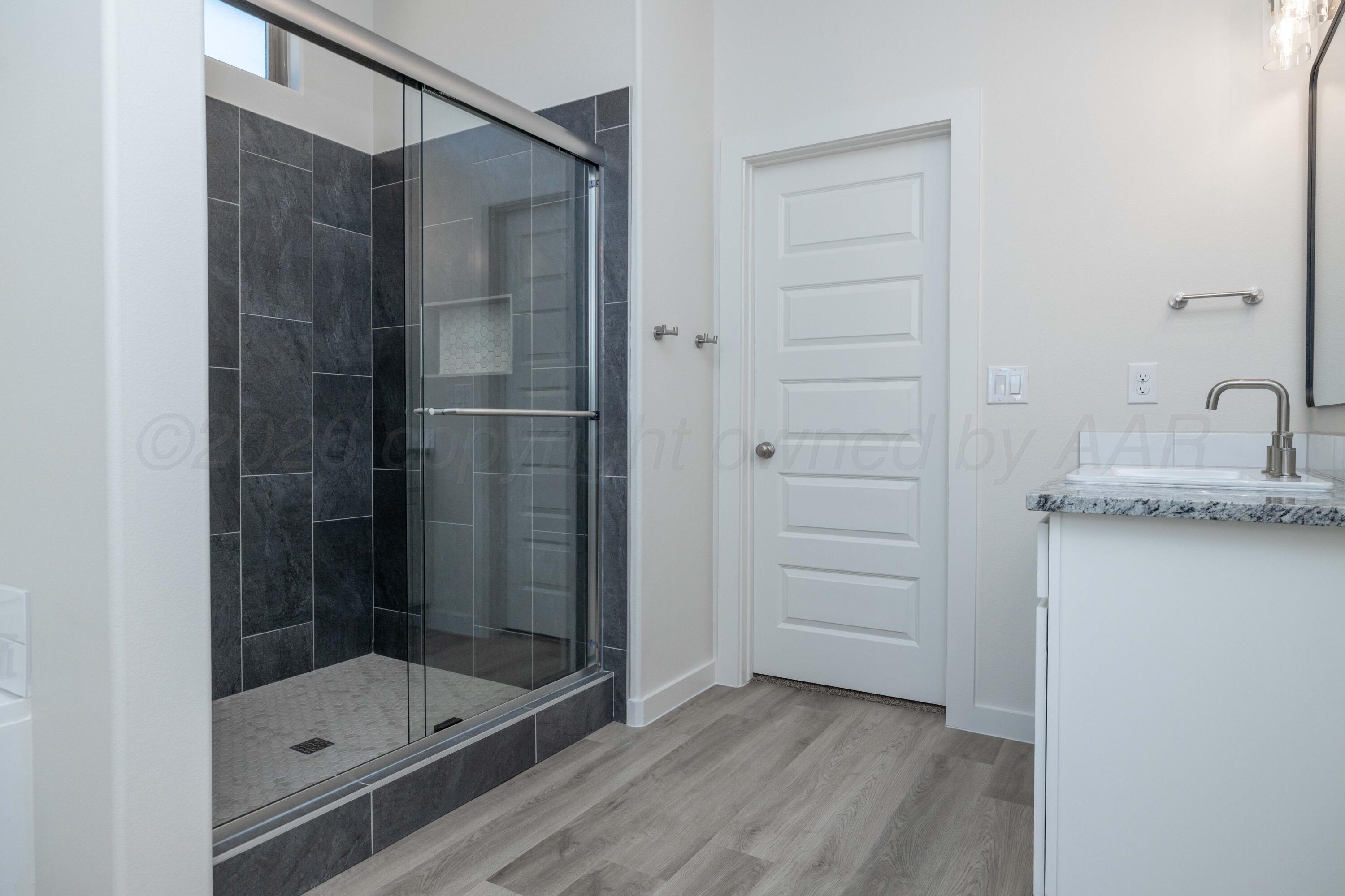 3006 Frontier Lane Amarillo, TX 79124 - Photo 5 of 16 a bathroom with a shower and a sink