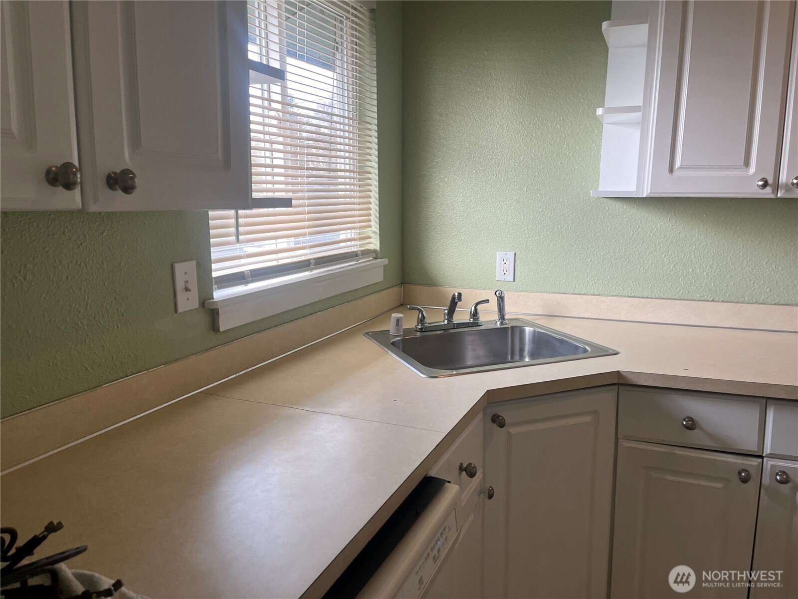 220 West 4th Street Aberdeen, WA 98520 - Photo 13 of 26 a kitchen with a sink and cabinets