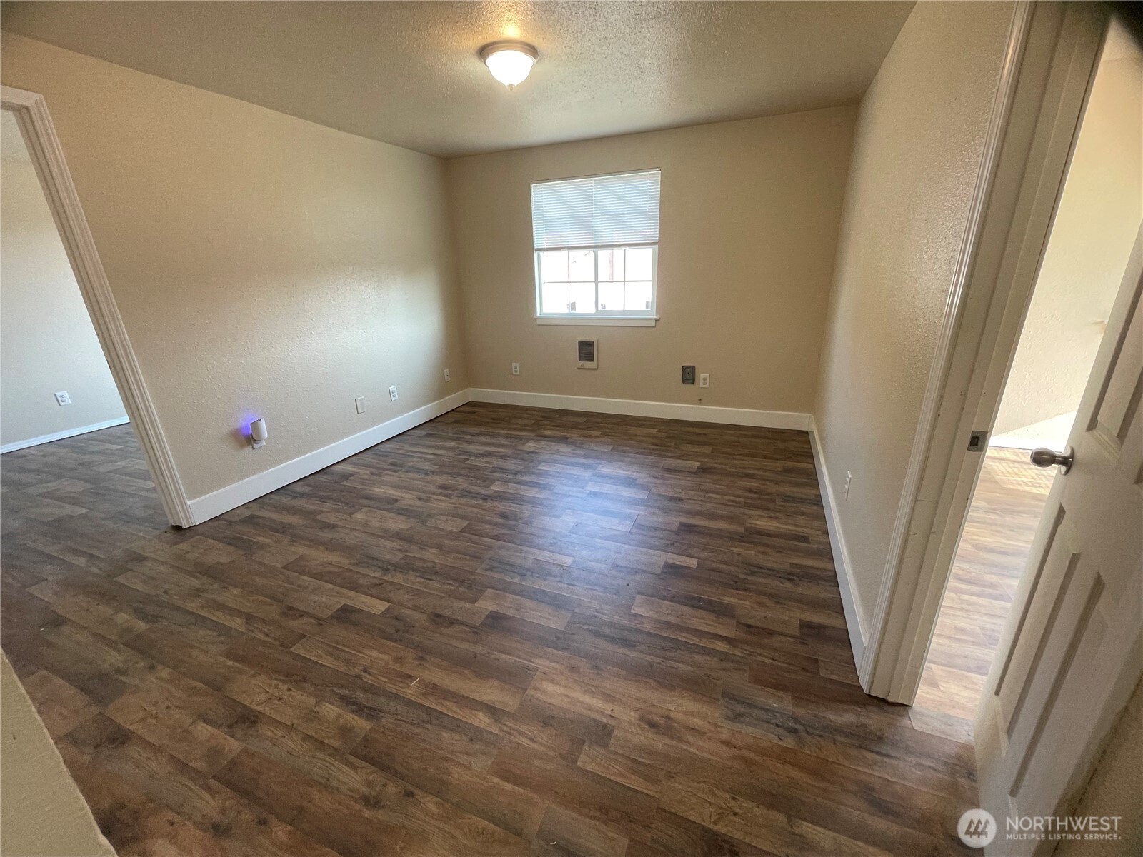 220 West 4th Street Aberdeen, WA 98520 - Photo 19 of 26 an empty room with wooden floor and windows
