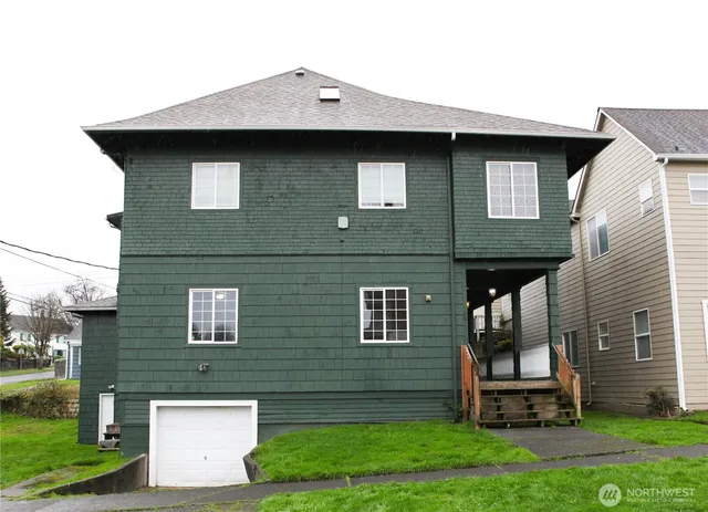 a front view of a house with a garden