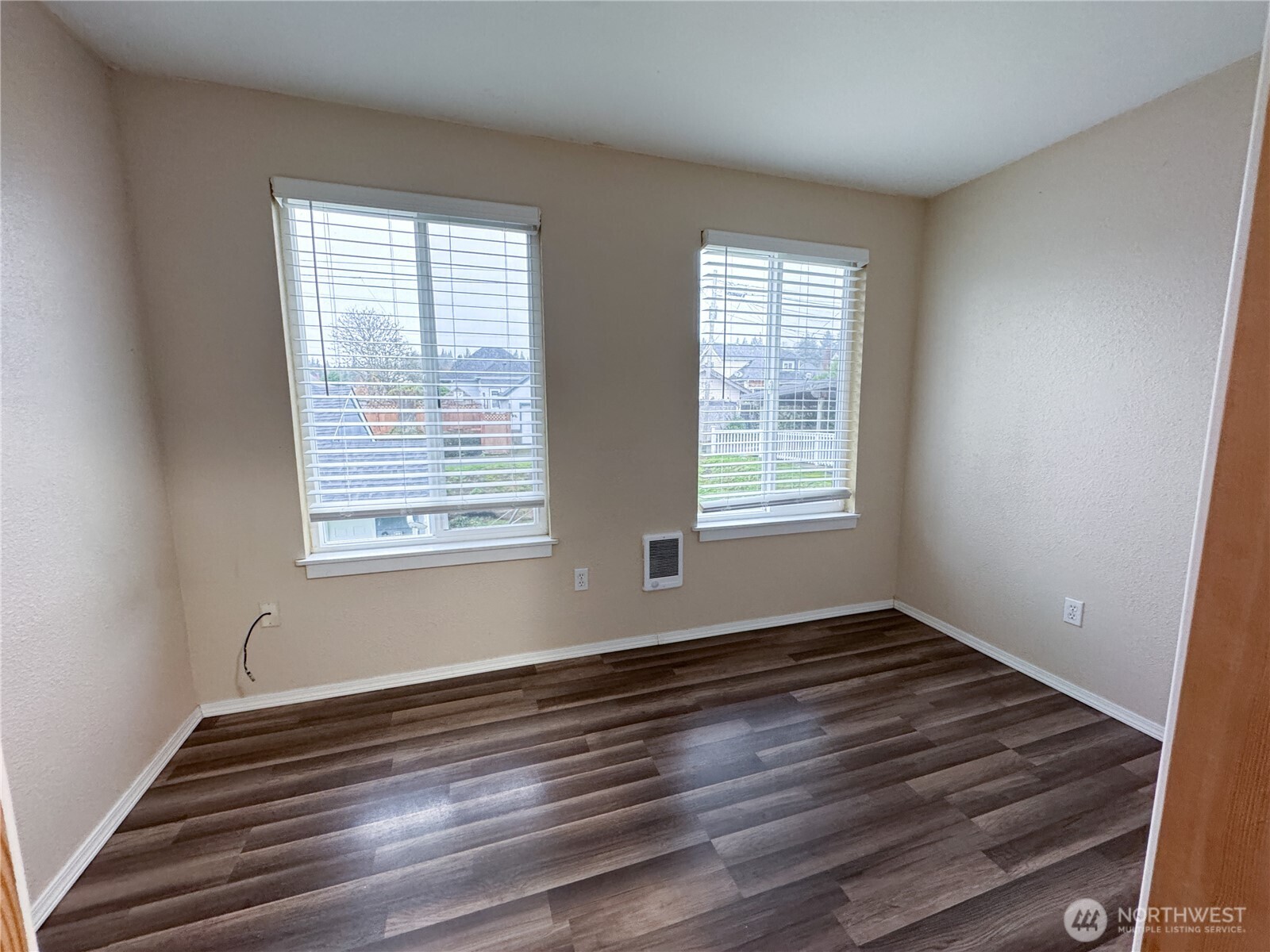 220 West 4th Street Aberdeen, WA 98520 - Photo 7 of 26 a view of an empty room with wooden floor and a window