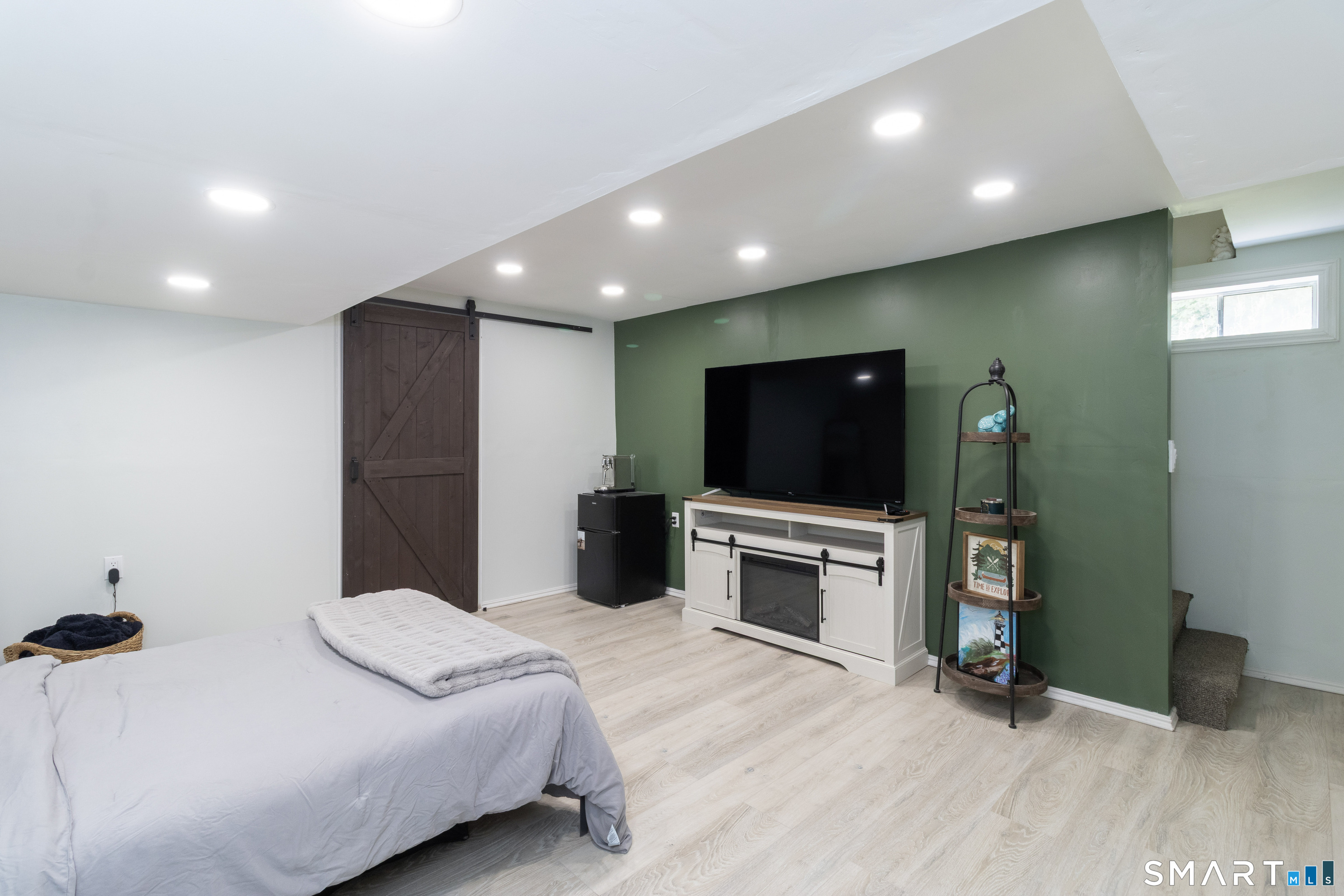656 Bartholomew Road, Unit 656 Middletown, CT 06457 - Photo 24 of 27 a bedroom with a bed and a flat screen tv