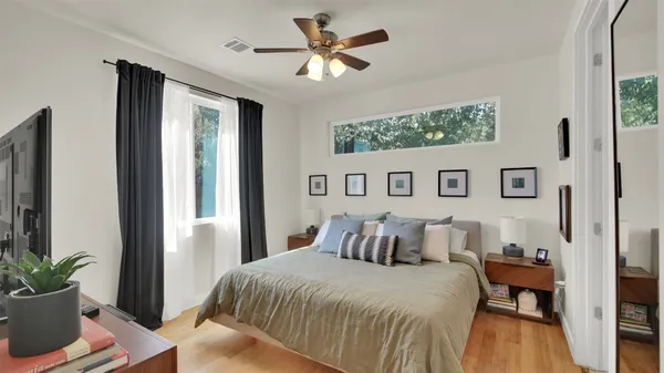 a bedroom with a large bed and a potted plant