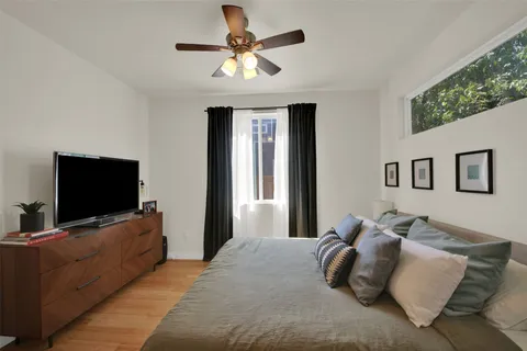 a bedroom with a large bed and a flat screen tv