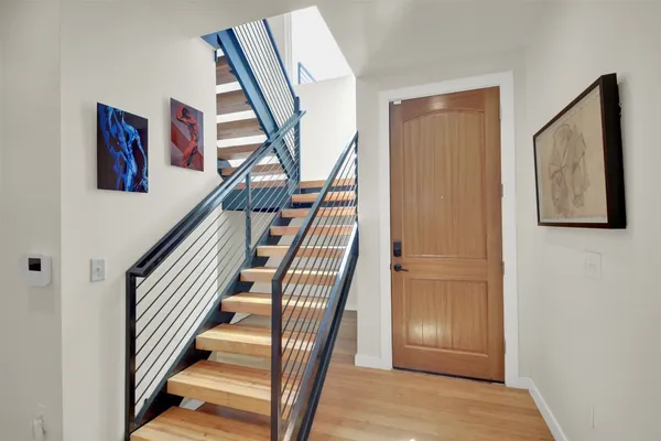 a view of an entryway with wooden floor