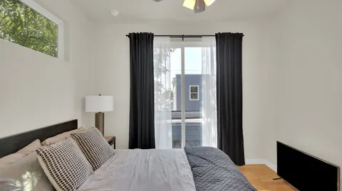 a bedroom with a bed and a window