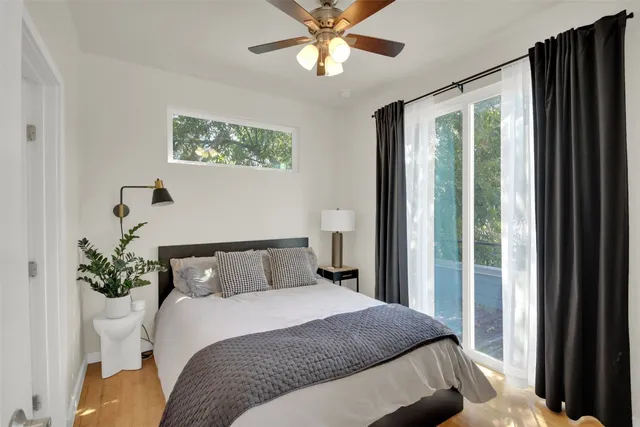 a bedroom with a large bed and a window