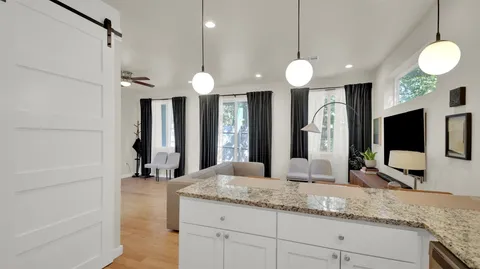 a bathroom with a sink a large mirror and a shower