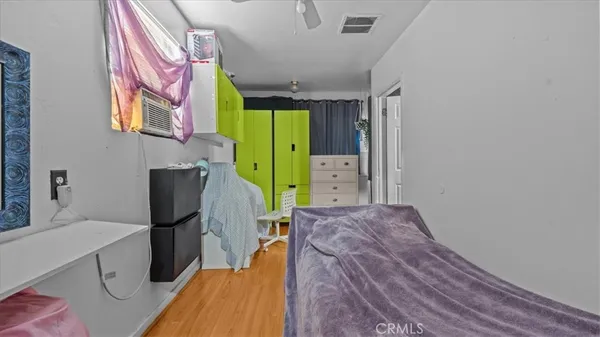 a bedroom with a bed dresser and a window